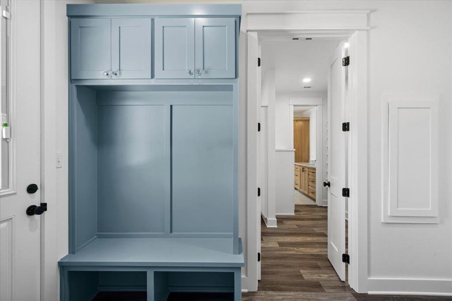 Mudroom with dark wood-style floors and baseboards