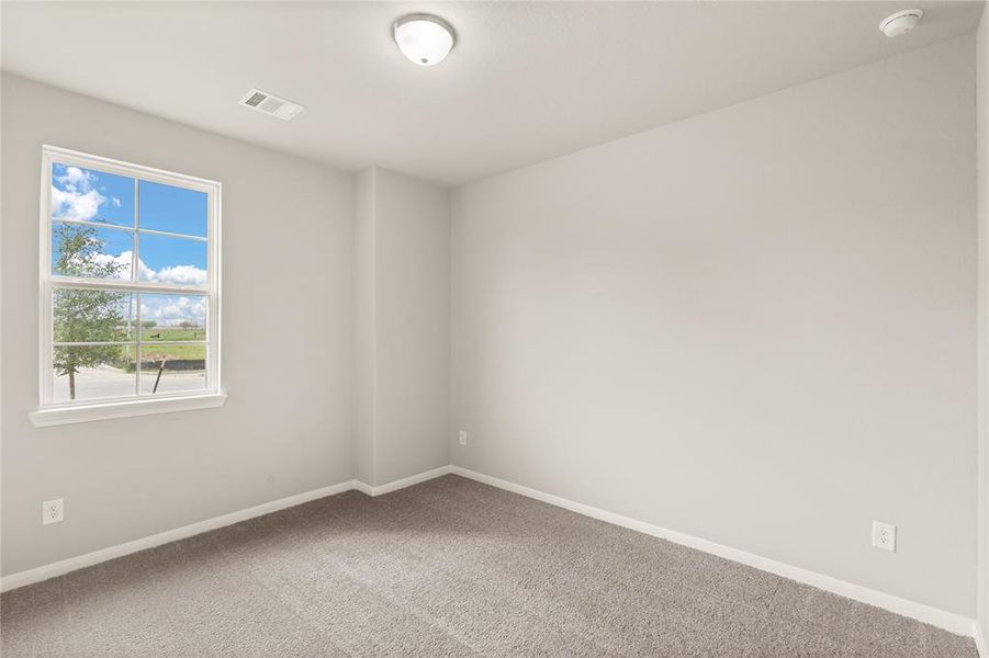 Your secondary bedroom features plush carpet, fresh paint, closet, and a large window that lets in plenty of natural lighting.