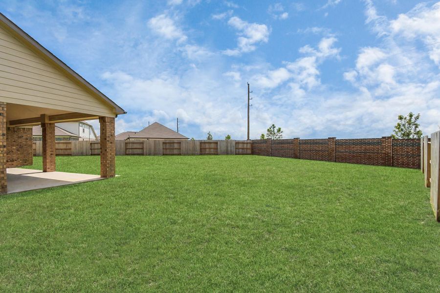 Backyard retreat, offering an abundance of space for kids to play and explore. The possibilities are endless in this outdoor haven, where the joy of open-air activities and family gatherings awaits. Sample photo of completed home with similar floor plan. Actual colors and selections may vary. Backyard retreat, offering an abundance of space for kids to play and explore. The possibilities are endless in this outdoor haven, where the joy of open-air activities and family gatherings awaits. Sample photo of completed home with similar floor plan. Actual colors and selections may vary.