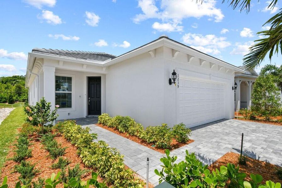 Front exterior of a new home in Costa Pointe, Vero Beach, FL, highlighting curb appeal (Image 14).