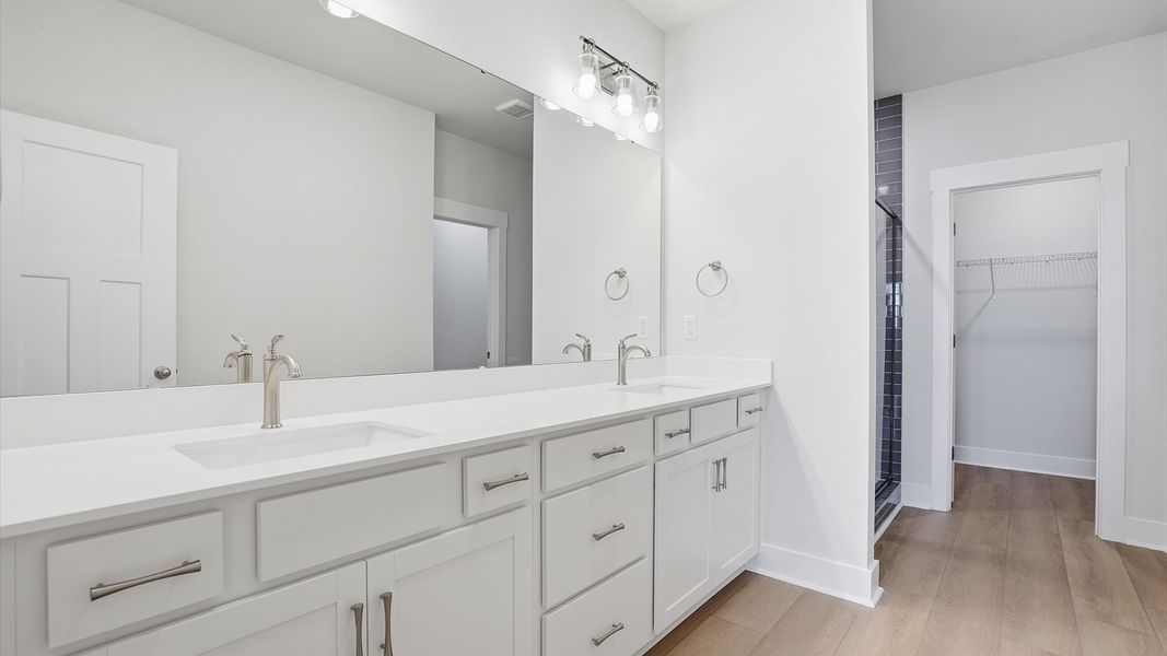 Notable primary bath featuring dual vanity, walk-in shower, and tasteful design touches throughout in Anderson, SC