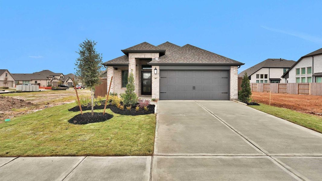 Front exterior of a new home in Brookewater 40', Rosenberg, TX, highlighting curb appeal (Image 11).