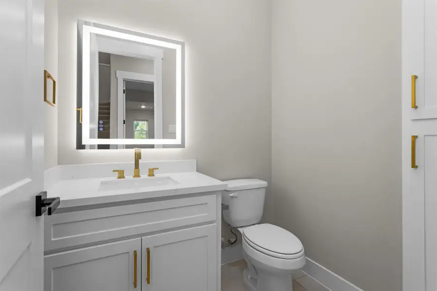 Convenient half bath located near the main living area with modern design touches. Convenient half bath located near the main living area with modern design touches.