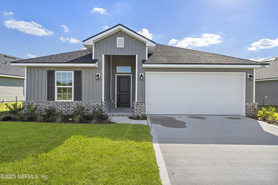 Front exterior of a new home in Summerglen, Jacksonville, FL, highlighting curb appeal (Image 1).