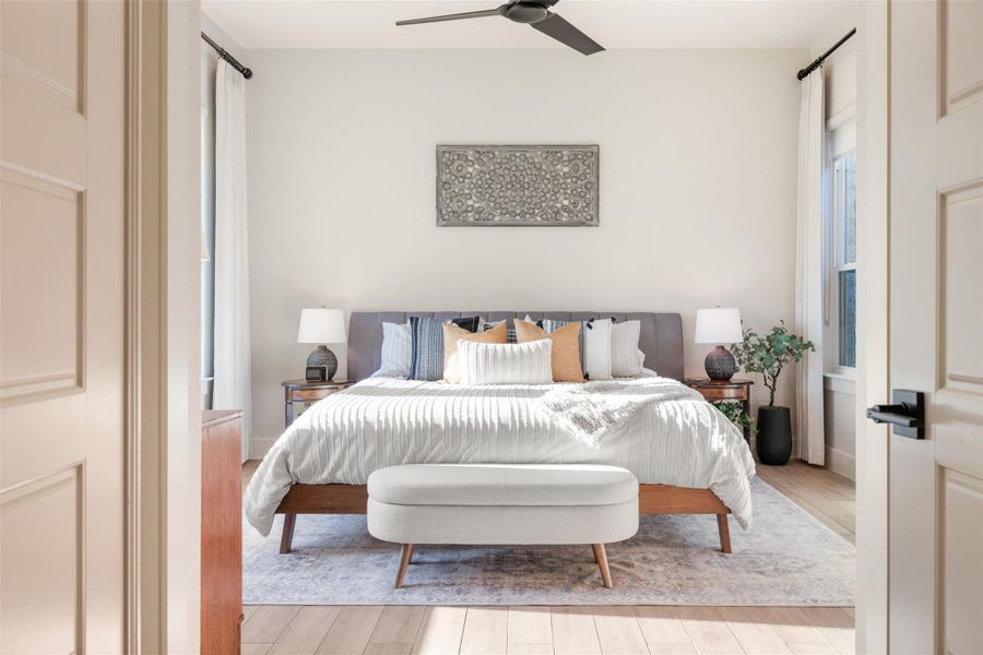 Bedroom with light hardwood / wood-style floors and ceiling fan Bedroom with light hardwood / wood-style floors and ceiling fan