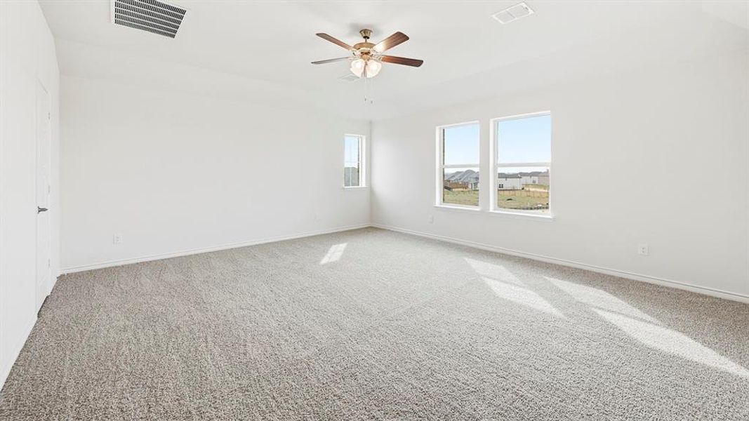 Spare room featuring carpet flooring and ceiling fan