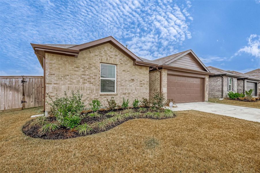 Front exterior of a new home in Mill Creek, Magnolia, TX, highlighting curb appeal (Image 22).