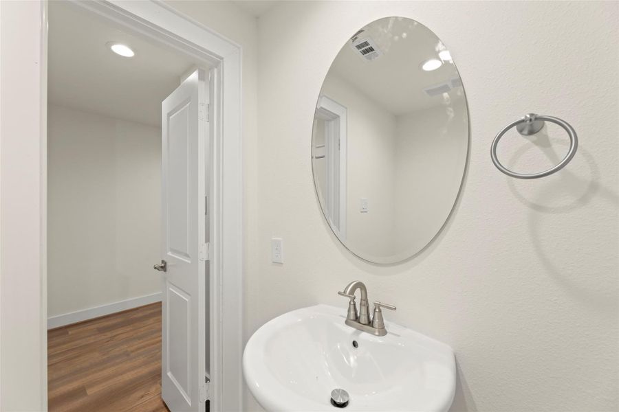 This photo shows the half bathroom on the third level.