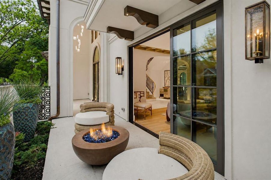Front courtyard featuring gas lamps and a gas fireplace