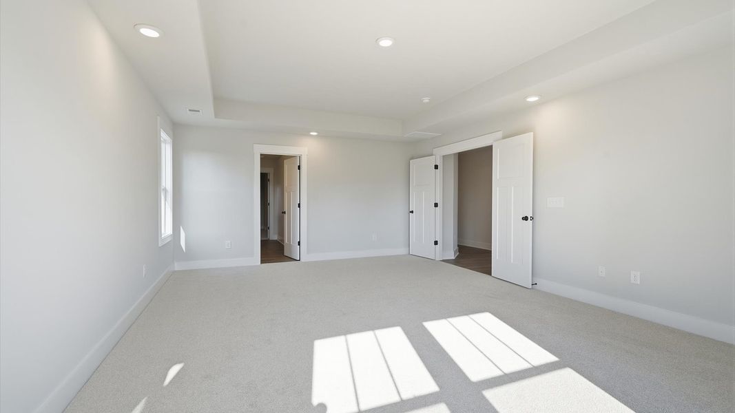 Vibrant natural light fills this exceptional primary suite with eye-catching details