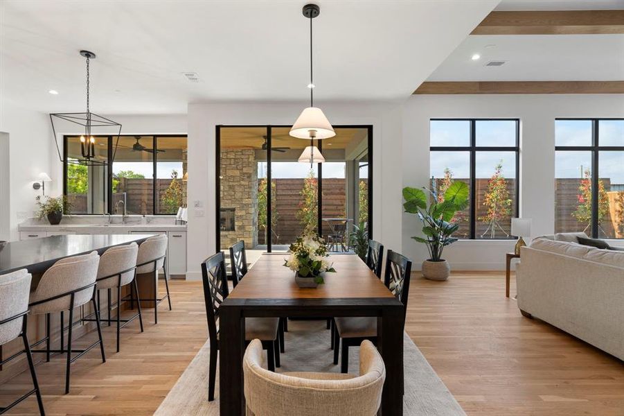 Dining space with light wood-style flooring and recessed lighting Dining space with light wood-style flooring and recessed lighting
