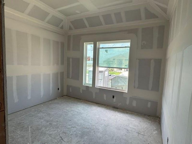 Ready for finishes, this room boasts new drywall and a bright window.
