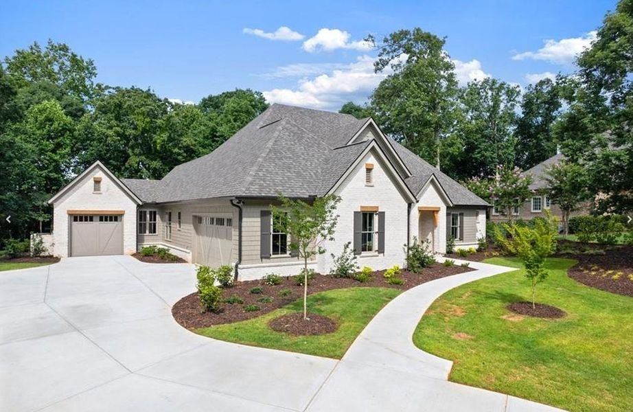Front exterior of a new home in , Cumming, GA, highlighting curb appeal (Image 1). Front exterior of a new home in , Cumming, GA, highlighting curb appeal (Image 1).