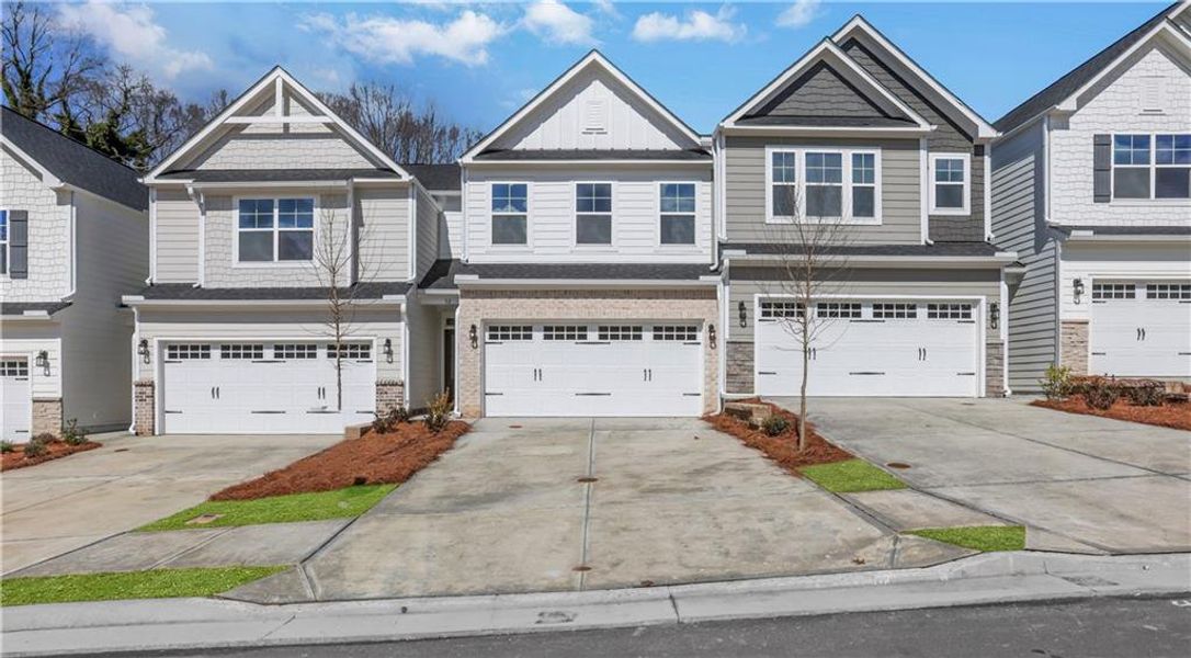 Front exterior of a new home in Villas at Dawsonville Townhomes, Dawsonville, GA, highlighting curb appeal (Image 2). Front exterior of a new home in Villas at Dawsonville Townhomes, Dawsonville, GA, highlighting curb appeal (Image 2).