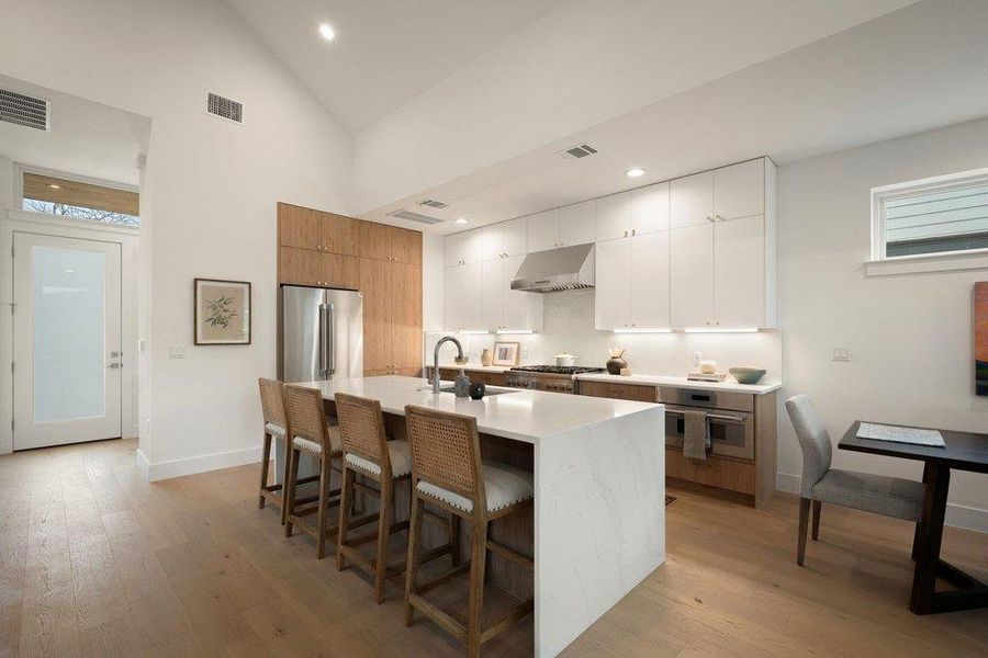 Culinary aspirations come alive in this sunlit kitchen, featuring a spacious island and gleaming stainless steel appliances. Culinary aspirations come alive in this sunlit kitchen, featuring a spacious island and gleaming stainless steel appliances.