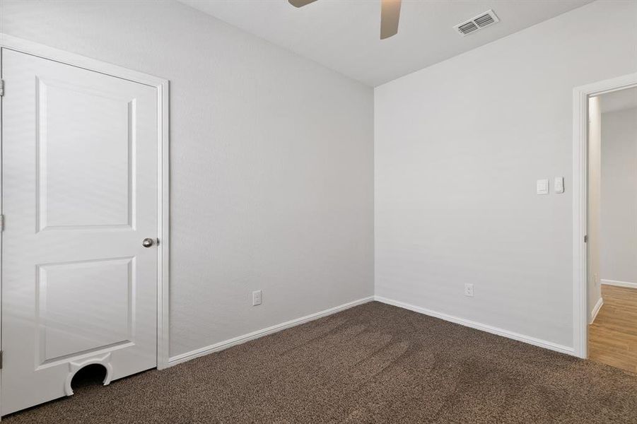Unfurnished bedroom featuring carpet floors and a ceiling fan