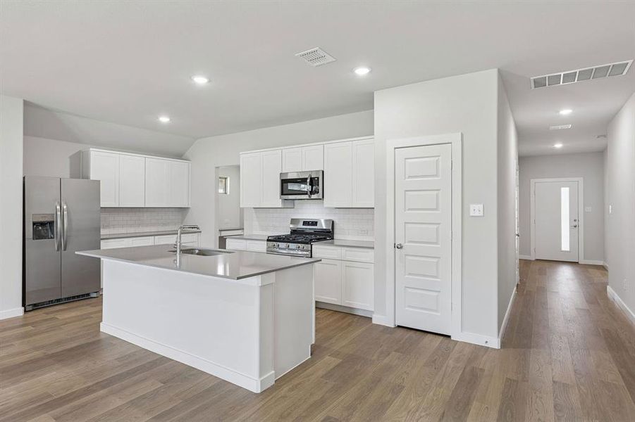 Kitchen in the Harrison home plan by Trophy Signature Homes – REPRESENTATIVE PHOTO