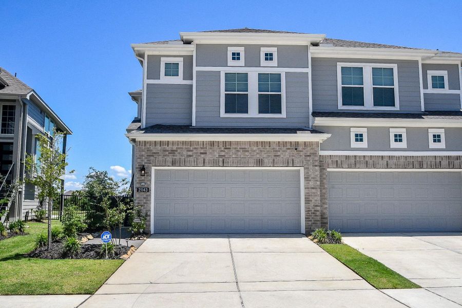 Front exterior of a new home in Bridgeland 45's, Cypress, TX, highlighting curb appeal (Image 2). Front exterior of a new home in Bridgeland 45's, Cypress, TX, highlighting curb appeal (Image 2).
