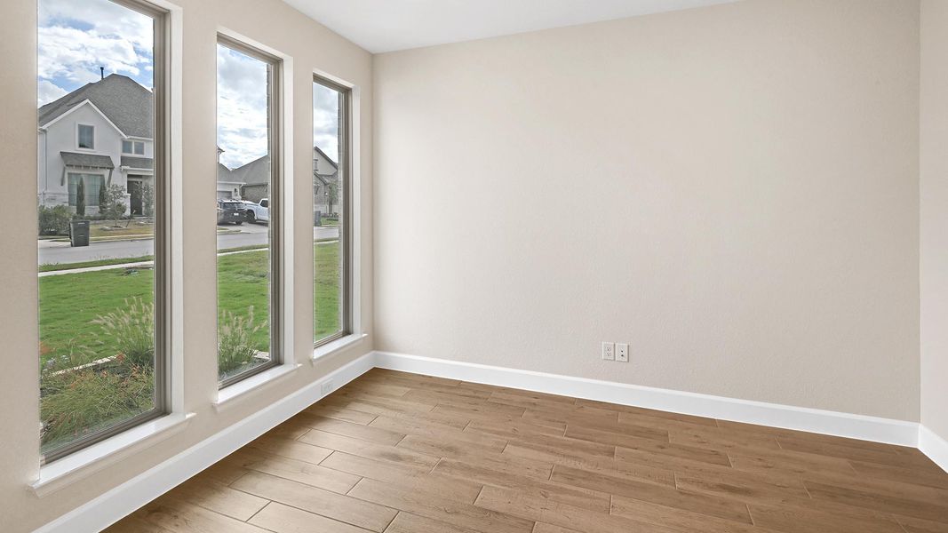Unfurnished room with baseboards and wood finished floors
