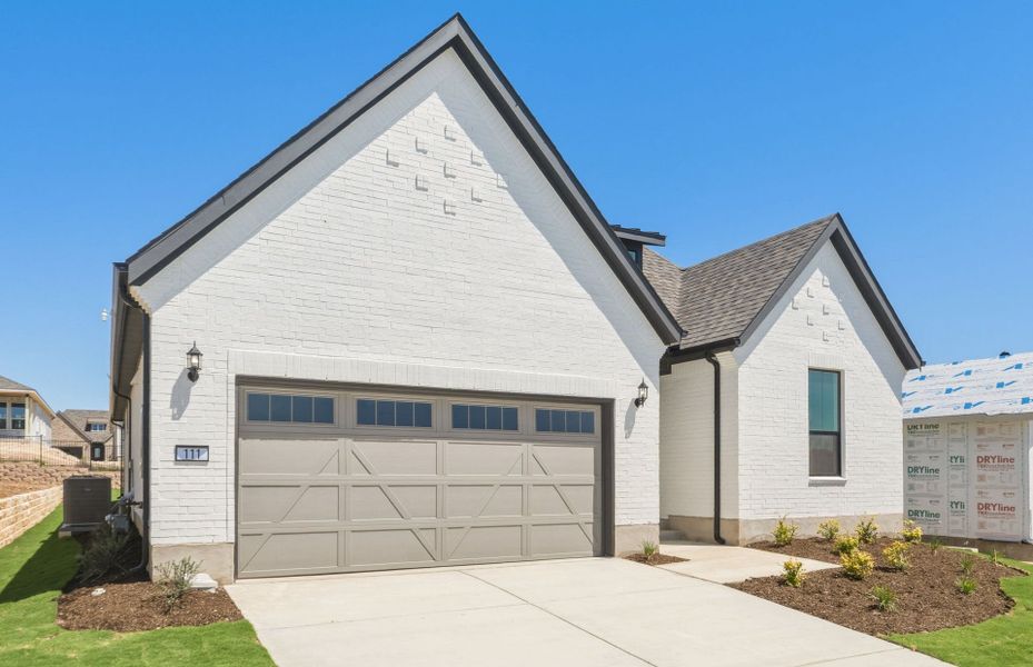 Front exterior of a new home in Sun City Texas, Georgetown, TX, highlighting curb appeal (Image 20).