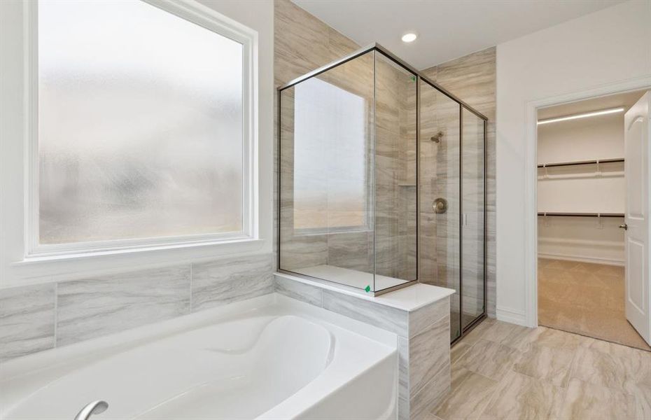 Owner's suite with oversized tub*real home pictured