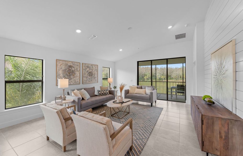 Gathering room with high ceilings and glass sliding-door to covered lanai