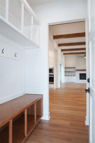 Mudroom featuring hardwood / wood-style floors and beam ceiling