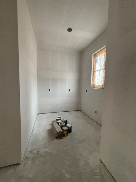 This will be your walk in pantry featuring a mini drink fridge with cabinets and quartz countertops. It will have floating shelves and plugs for appliances!