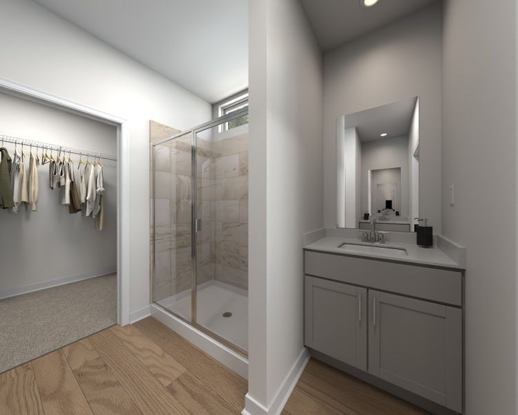 The primary bathroom offers dual vanity sinks and a walk-in shower.