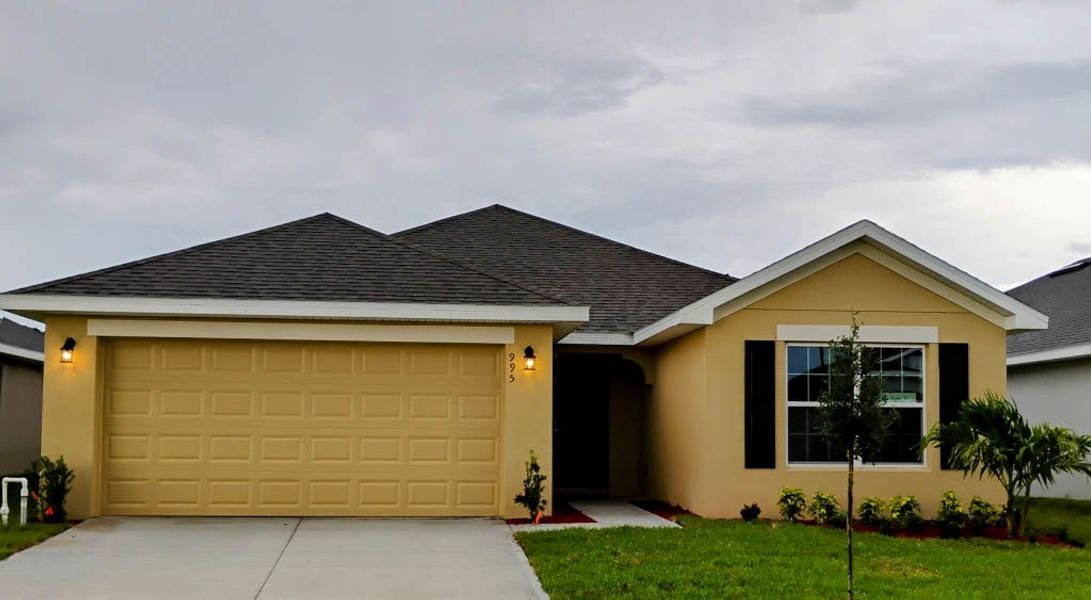 Front exterior of a new home in St. John Preserve, Palm Bay, FL, highlighting curb appeal (Image 2). Front exterior of a new home in St. John Preserve, Palm Bay, FL, highlighting curb appeal (Image 2).