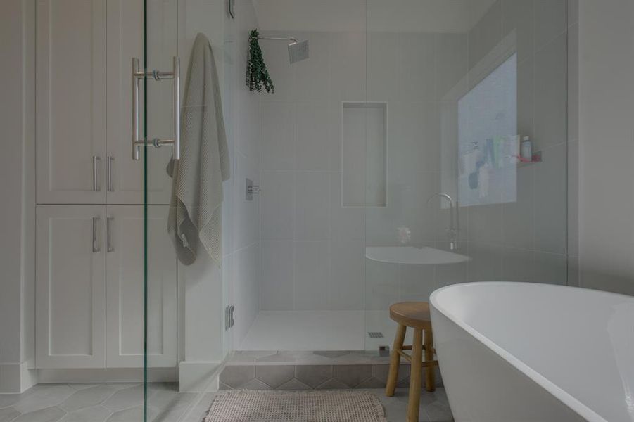 Bathroom with tile patterned floors and separate shower and tub