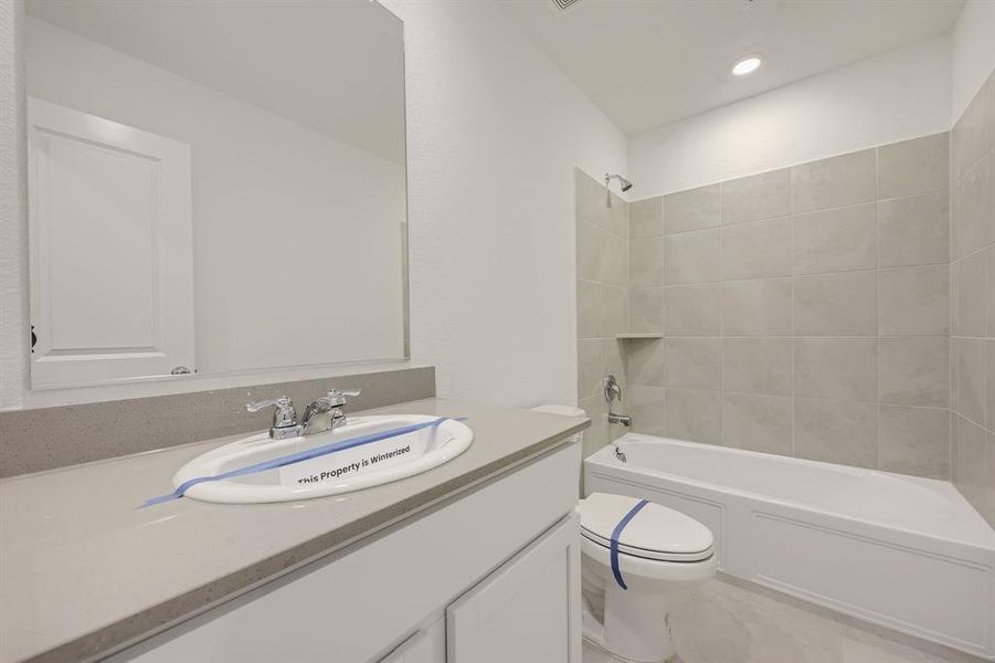 Second full bathroom featuring  shower combination and vanity