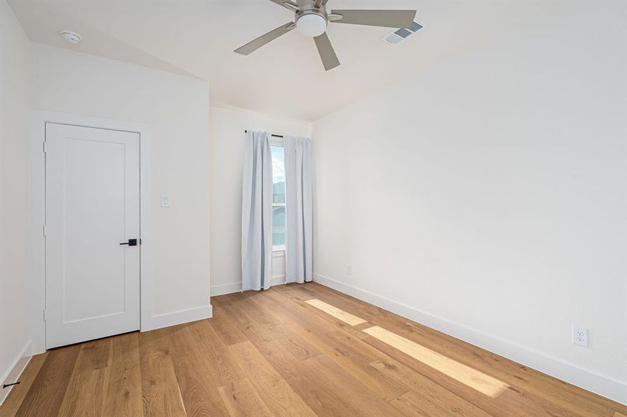 Unfurnished room featuring light wood finished floors and ceiling fan