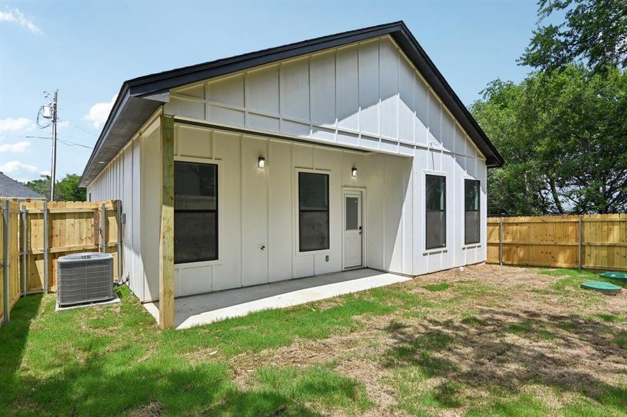 Back of property featuring board and batten siding, a patio, and a fenced backyard Back of property featuring board and batten siding, a patio, and a fenced backyard