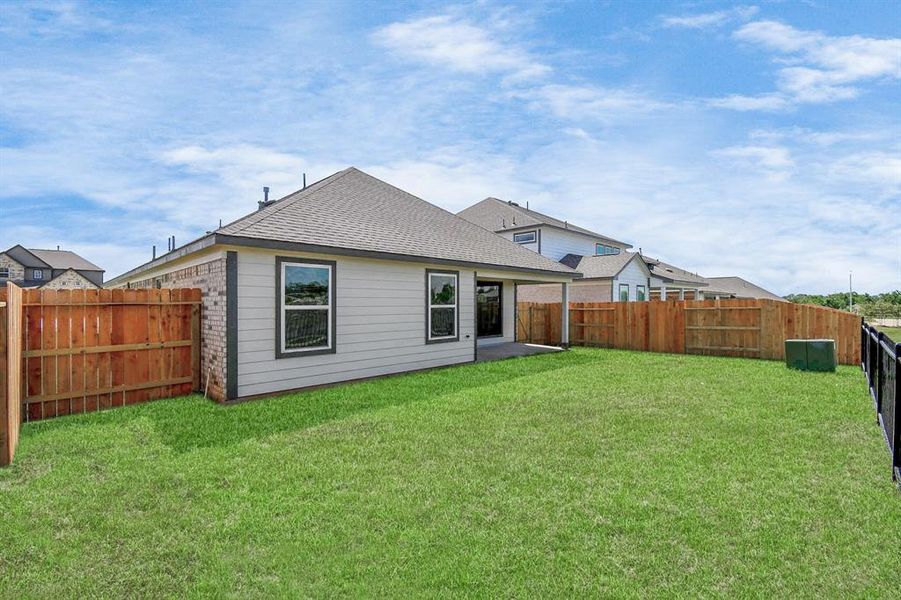 Explore the expansive backyard with its inviting covered patio—a perfect blend of space for the kids to play and adults to unwind.