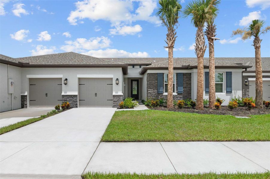 Front exterior of a new home in Celebration Pointe, Fort Pierce, FL, highlighting curb appeal (Image 2).