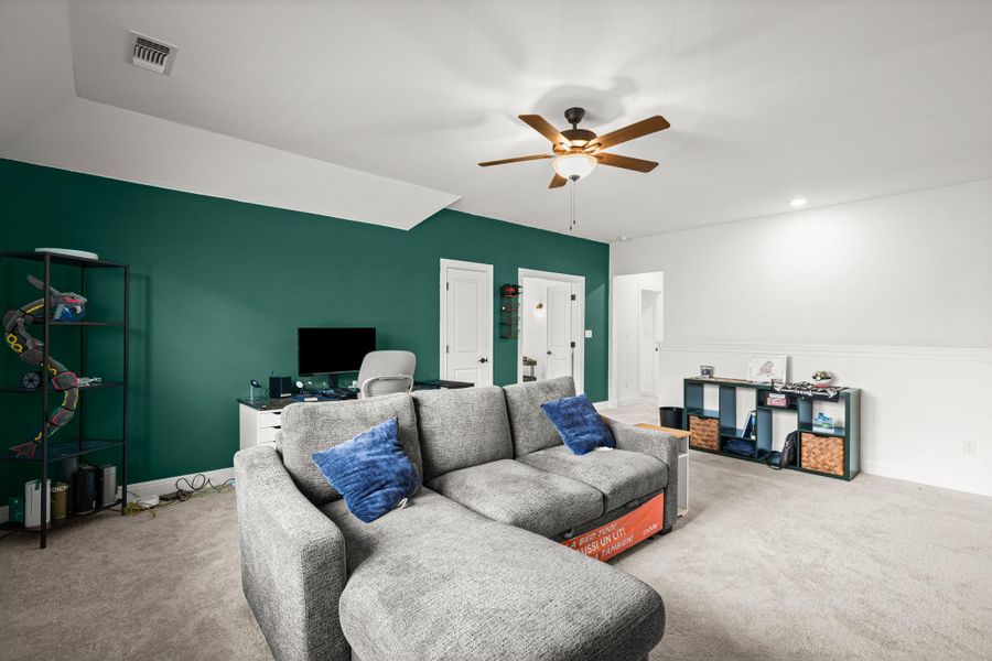 Carpeted living area featuring an office area, a ceiling fan, and recessed lighting Carpeted living area featuring an office area, a ceiling fan, and recessed lighting