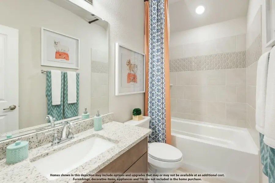 Bathroom with granite vanity, undermount sink, and tiled tub-shower combo with patterned curtain