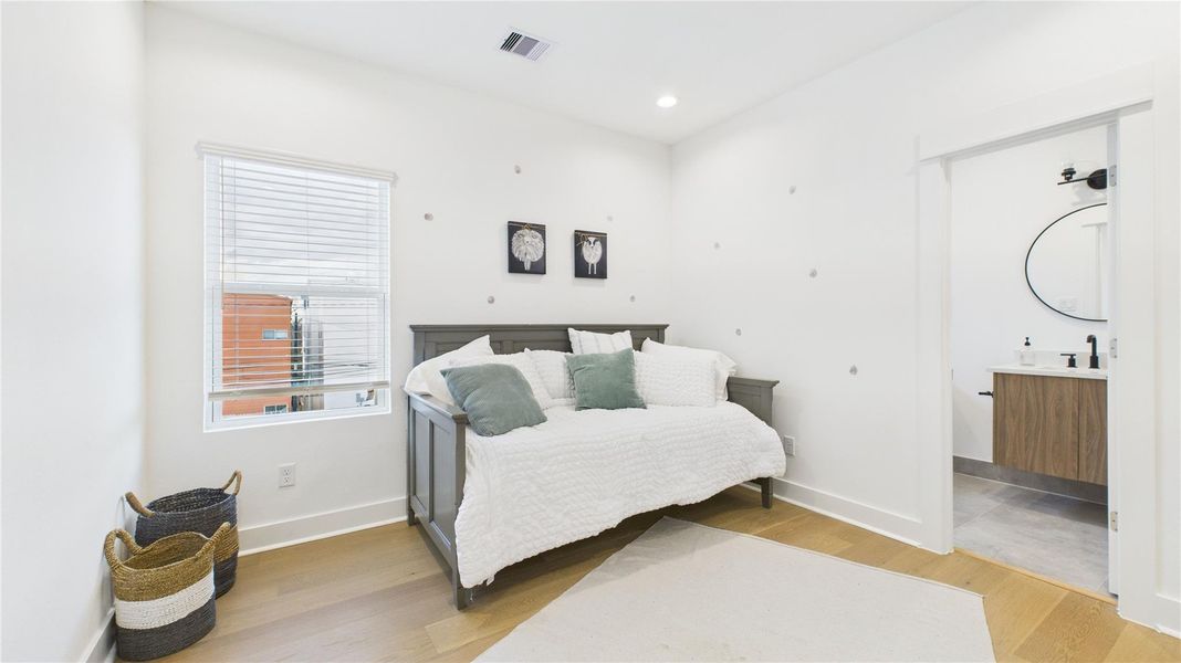 The second secondary bedroom on the third floor offers ample space and includes a private ensuite full bathroom, providing comfort and privacy in a well-appointed setting.