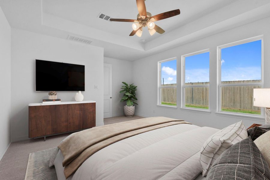 The primary bedroom is generously sized, creating a tranquil and spacious retreat that offers ample room for relaxation. Featuring plush carpet, high ceilings, fresh paint, and large windows that lets in natural lighting throughout the day.