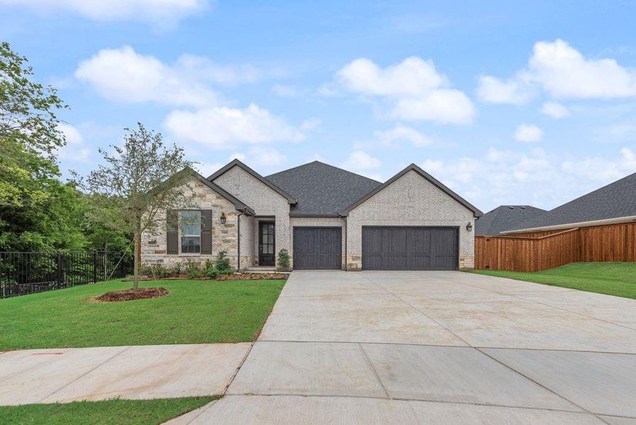 Front exterior of a new home in Valencia On The Lake, Little Elm, TX, highlighting curb appeal (Image 18).