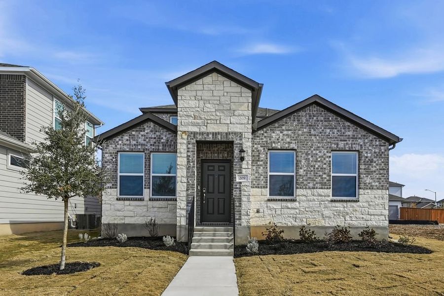 Front exterior of a new home in Emory Crossing, Hutto, TX, highlighting curb appeal (Image 1). Front exterior of a new home in Emory Crossing, Hutto, TX, highlighting curb appeal (Image 1).