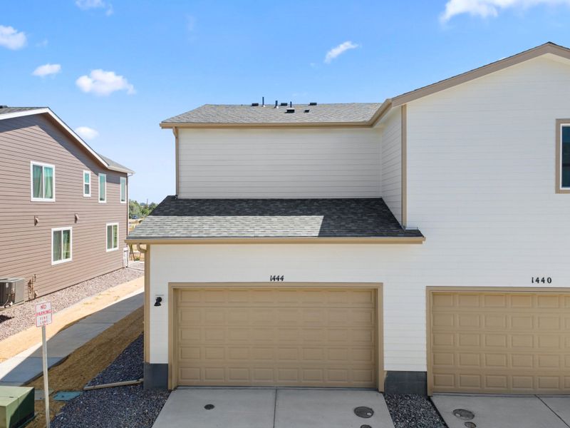 Front exterior of a new home in Spring Valley, Longmont, CO, highlighting curb appeal (Image 22).