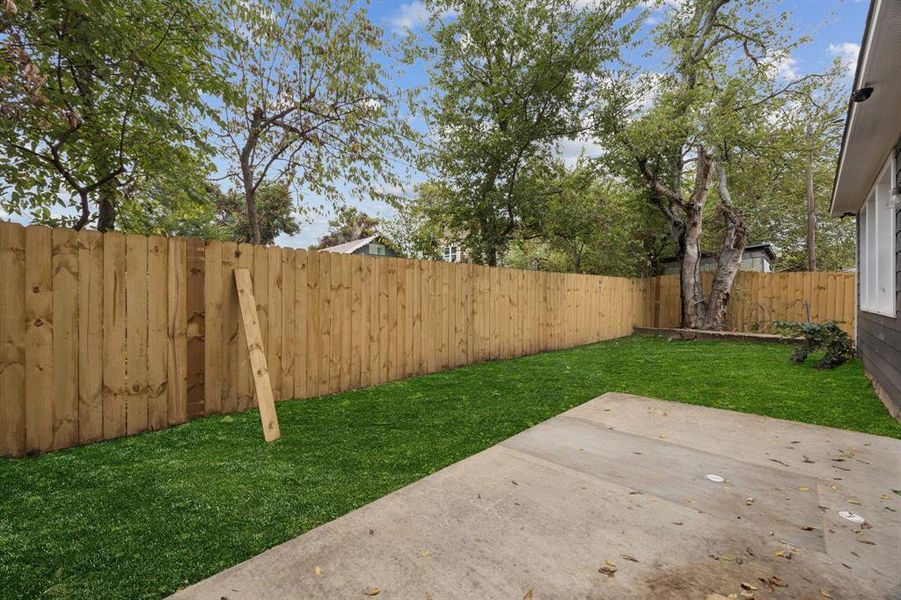 Fenced backyard with a patio