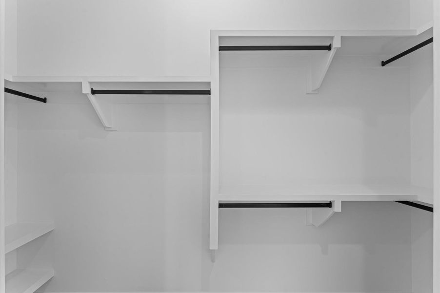 Walk-in closet for secondary bedroom. *Previous Brownstone Living project, selections and floor plans may vary.*