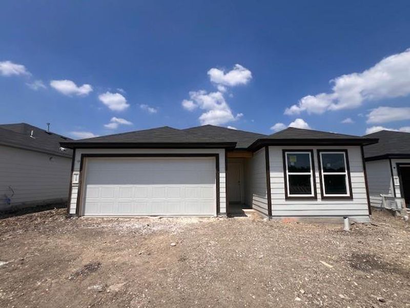 Front exterior of a new home in Marble Creek Crossing, Austin, TX, highlighting curb appeal (Image 1). Front exterior of a new home in Marble Creek Crossing, Austin, TX, highlighting curb appeal (Image 1).