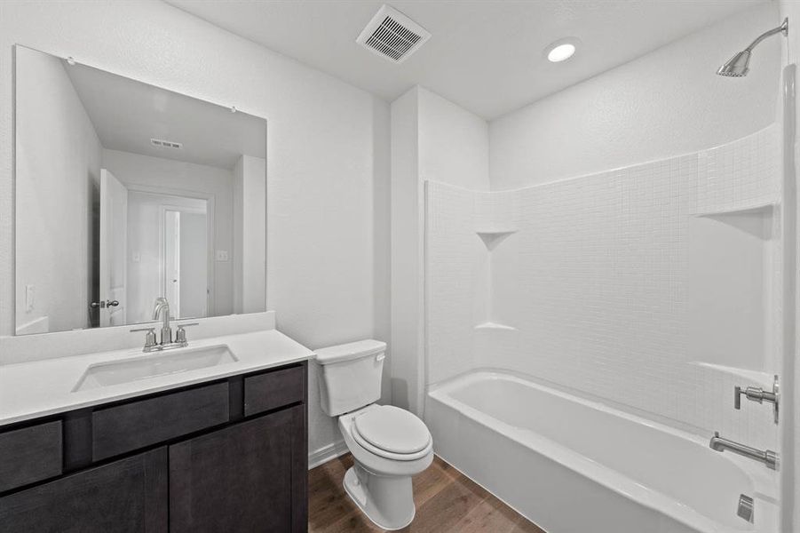 Full bathroom featuring vanity, wood-style flooring, toilet, and shower / bathtub combination