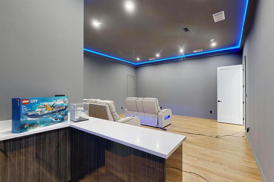 Cinema room with light wood-style flooring and recessed lighting Cinema room with light wood-style flooring and recessed lighting