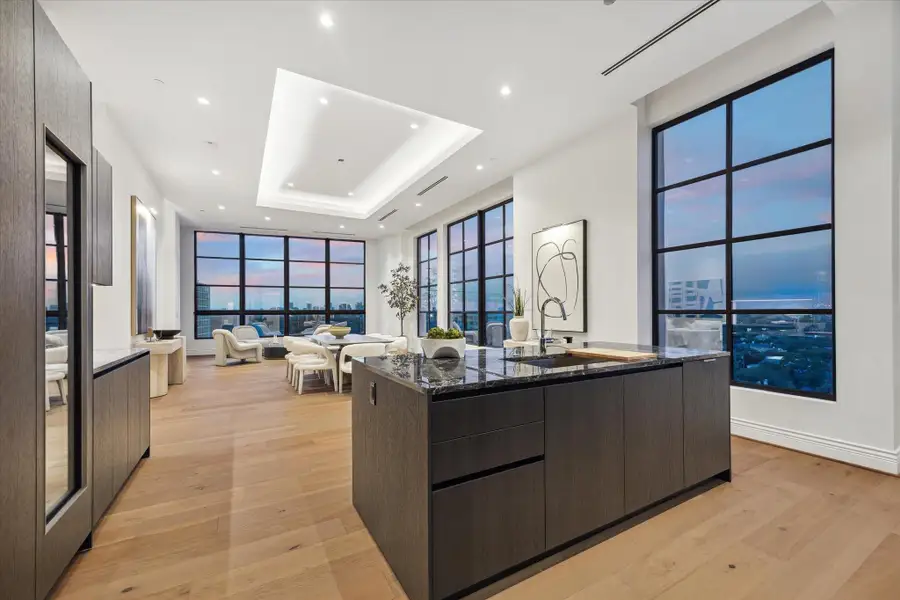 The kitchen island serves as a lovely perch and natural gathering place for taking in the magnificent surroundings. The kitchen island serves as a lovely perch and natural gathering place for taking in the magnificent surroundings.