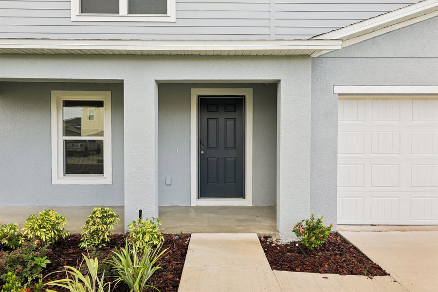 A white house with a black door. A white house with a black door.